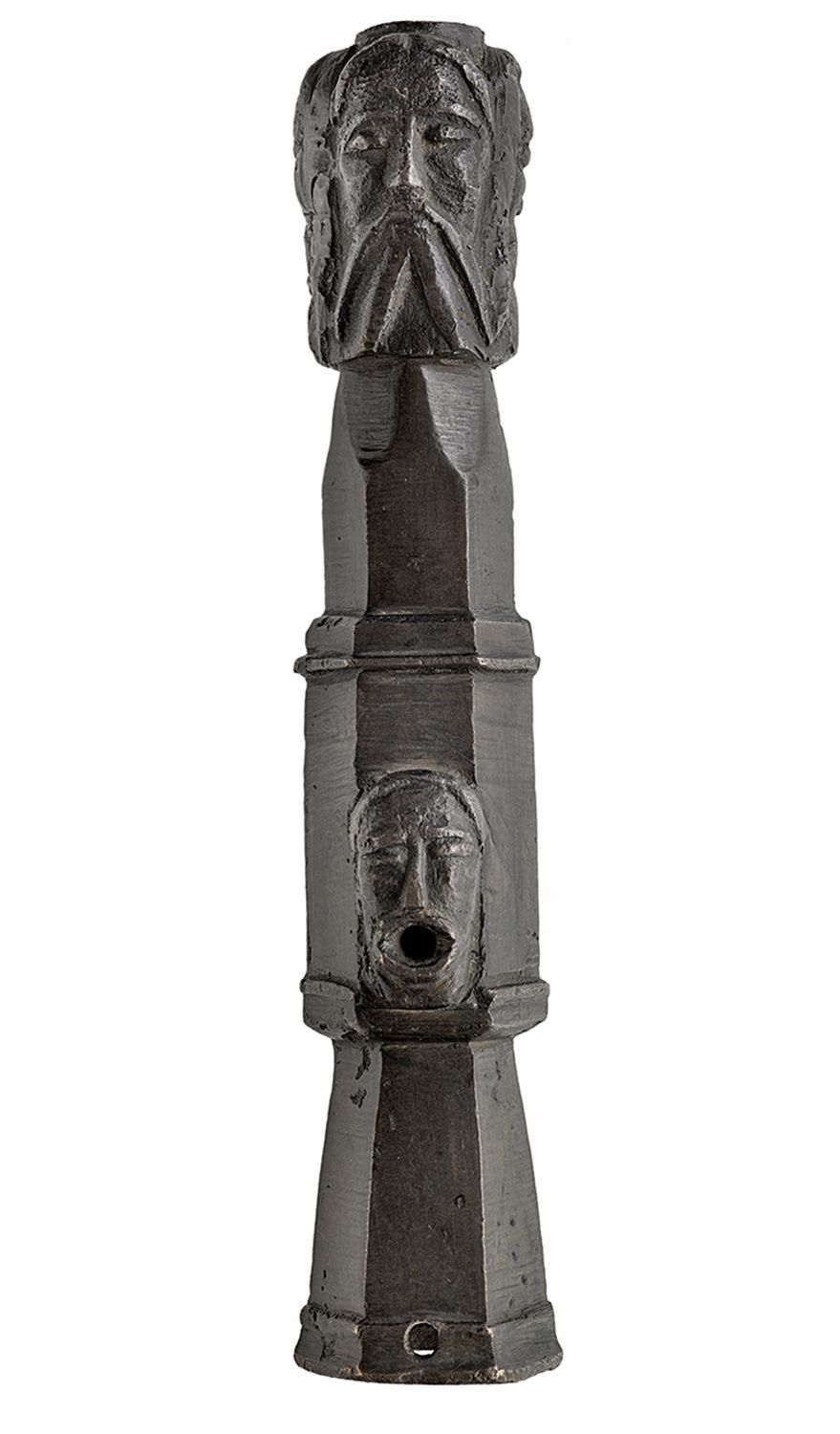 A bronze hexagonal tube in four sections decorated with bearded faces