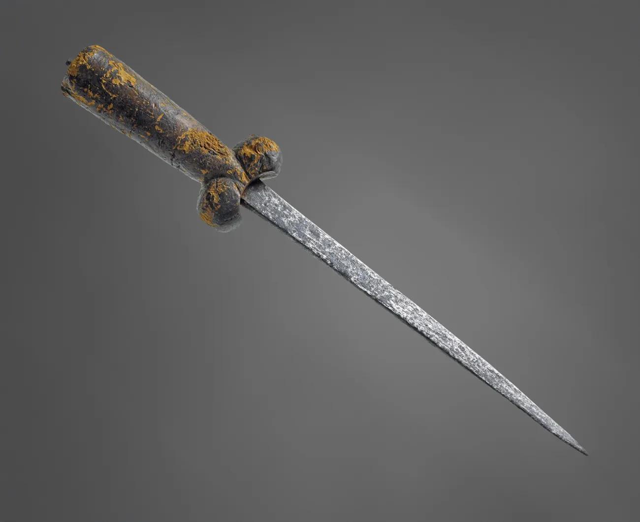 a sharp pointed dagger with a wooden handle