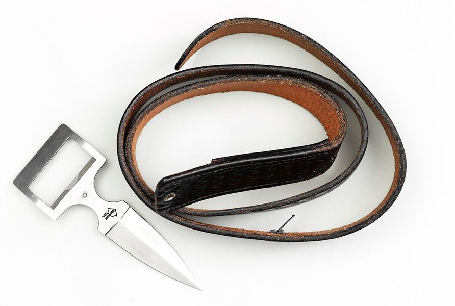 leather belt with a short silver coloured knife blade and handle