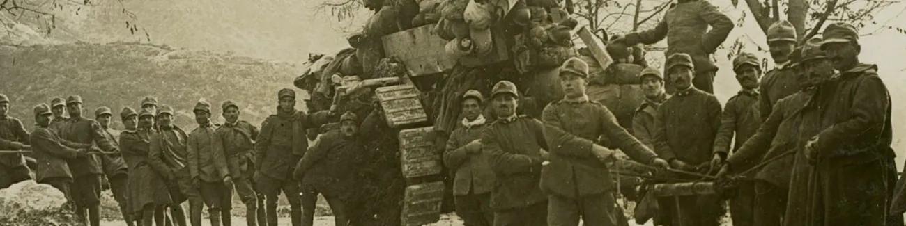 Austrian soldiers haul a disabled tank along a mountain road