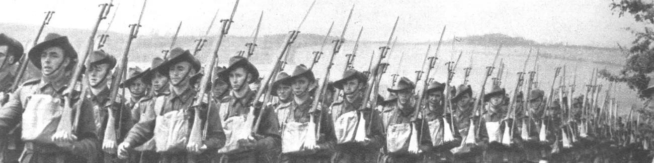 A contingent of Australian troops march past the camera