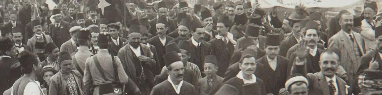 A group of Turkish civilians in the Ottoman Empire march to the recruitment office