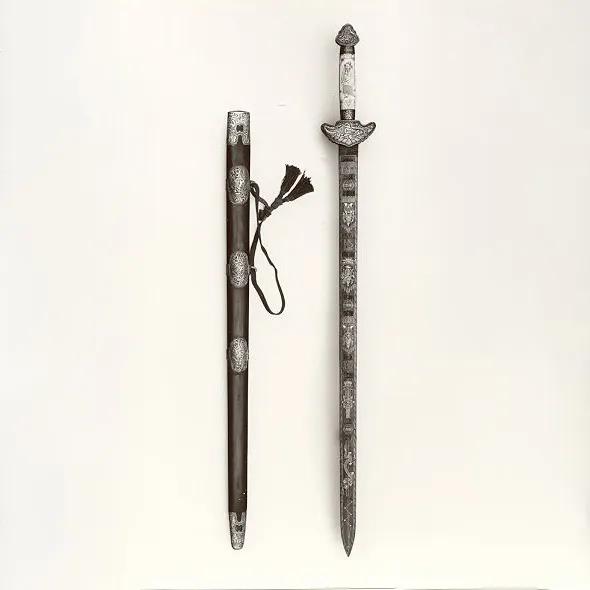 ornately decorated sword and scabbard laying side by side