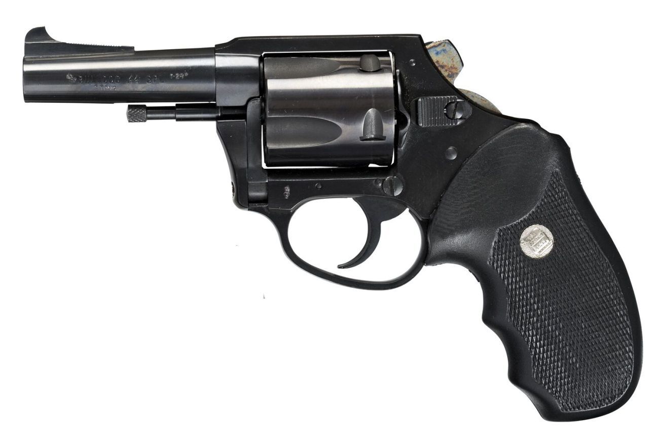 A small metal handgun or revolver in profile 