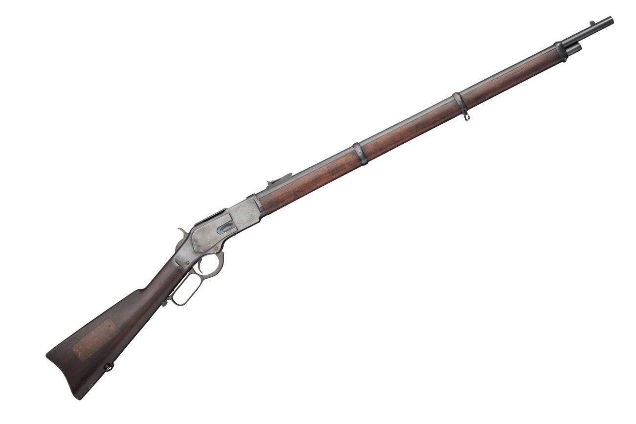 A profile of a Winchester rifle made of wood and steel pointing upwards 