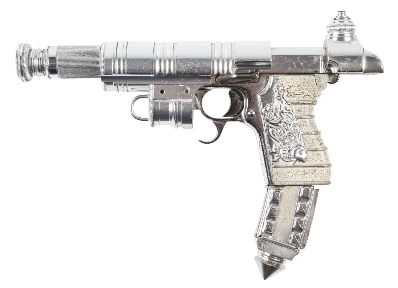 A profile of a silver pistol decorated with studs