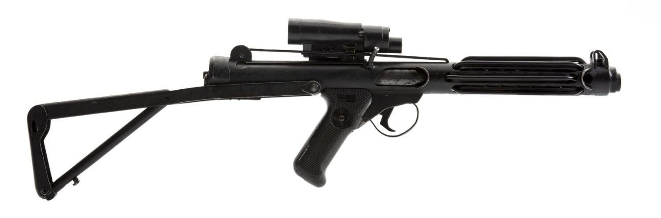 A long black metal submachine gun in profile 