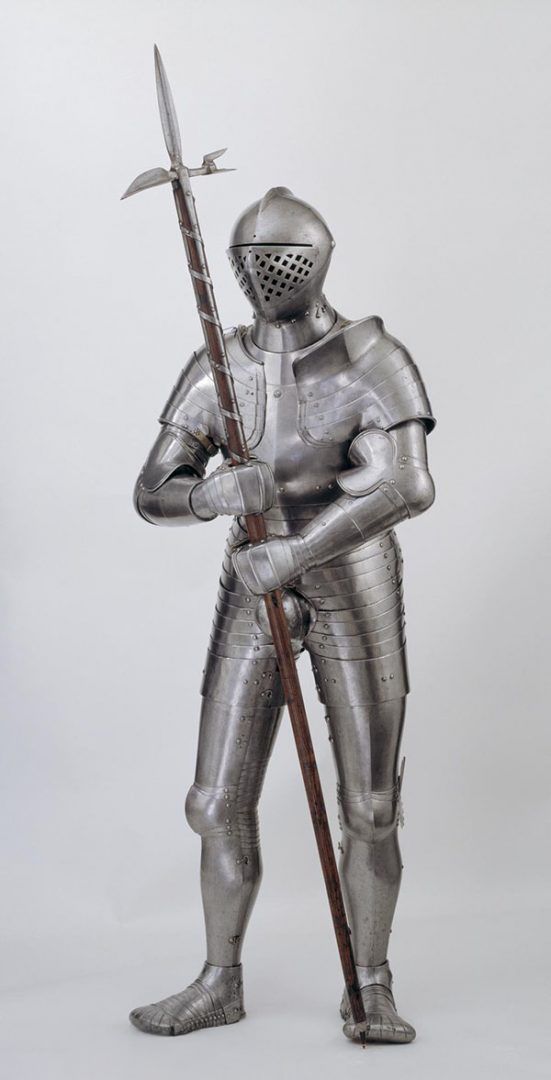 A full suit of armour holding a poleaxe 