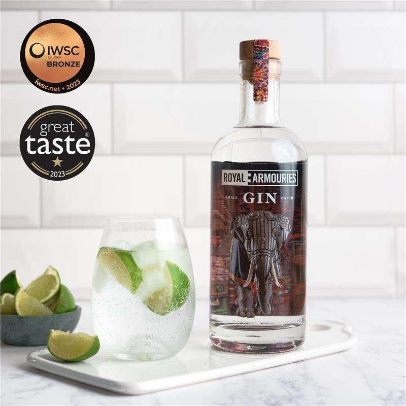 Royal Armouries Coastal Distillery Gin with Elephant Armour label next to a glass with drink and limes.
