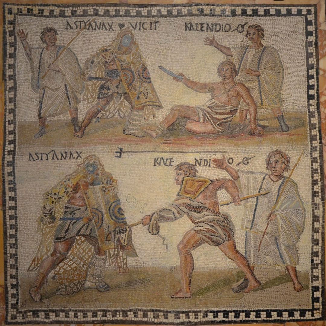 A mosaic of a duel between a retiarius and a secutor. The secutor kills his opponent as the lanista and summa rudis look on.