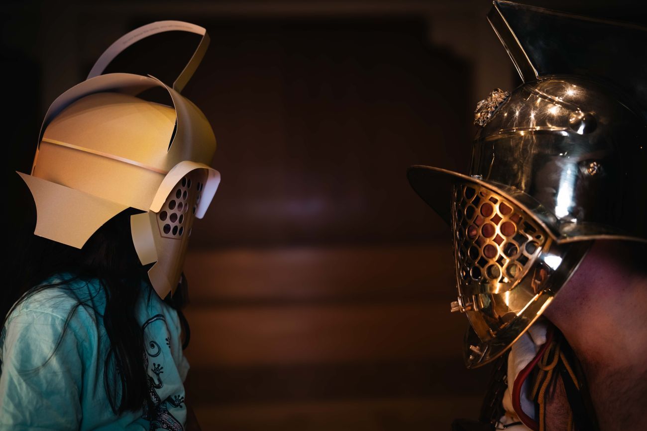 Child in paper helmet and gladiator
