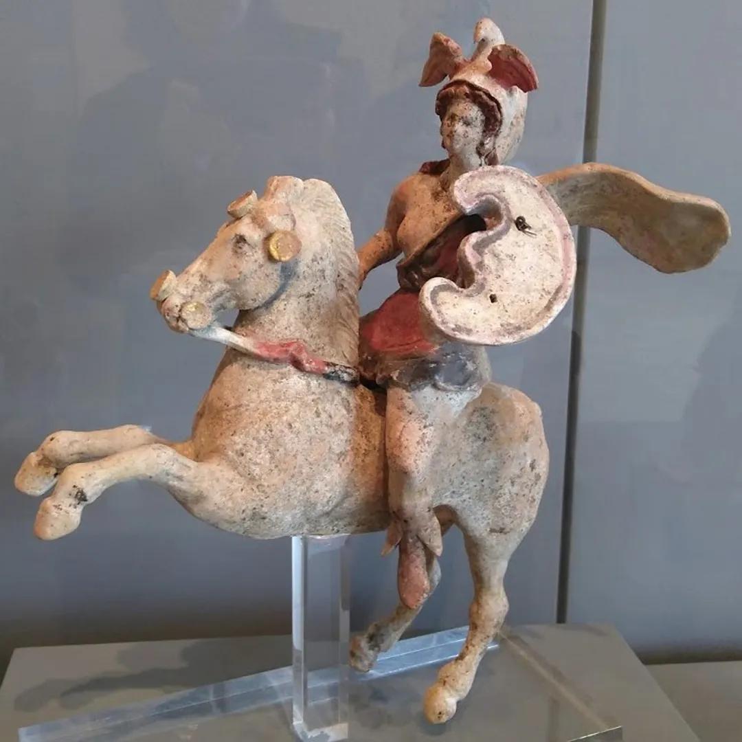 A painted stone statue of a mounted woman in armour styled from the Hellenistic period