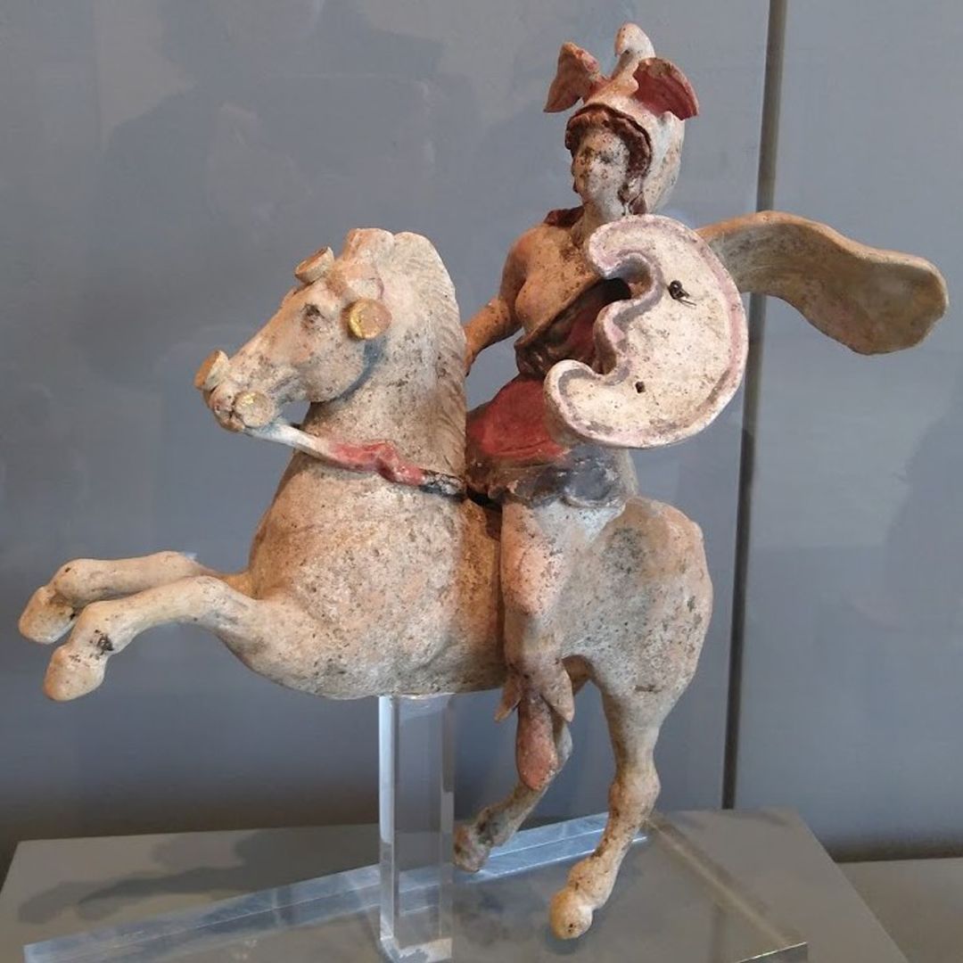 A painted stone statue of a mounted woman in armour styled from the Hellenistic period