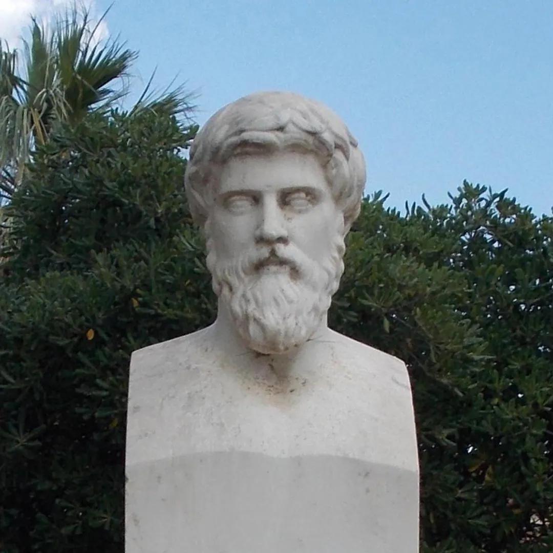 A white stone bust of a bearded man.