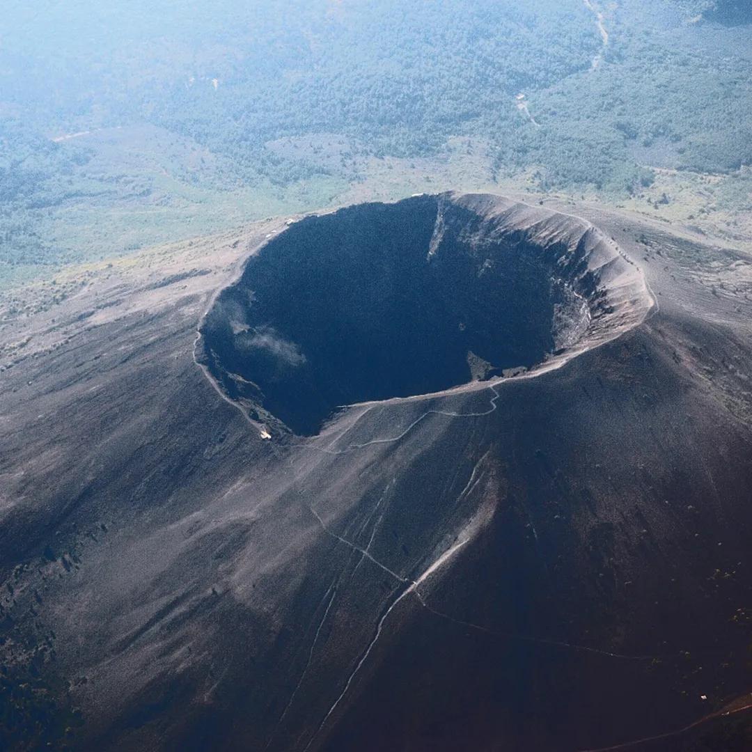 A colour aerial photo of a volcano looking down into the crater