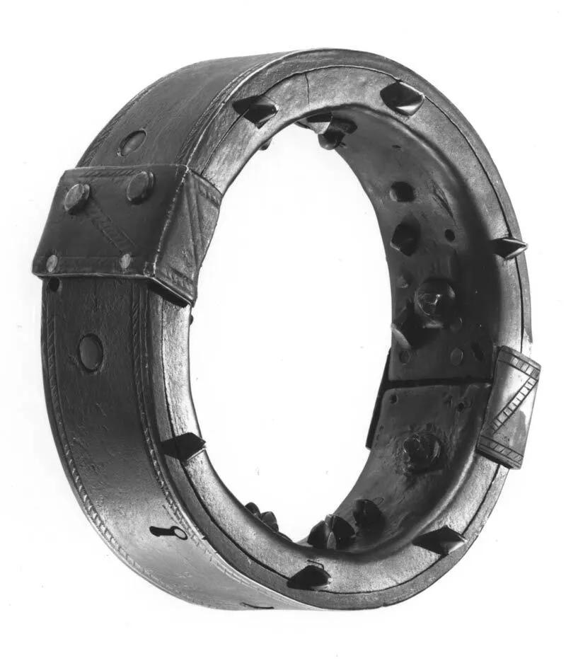 Iron collar photographed against white background