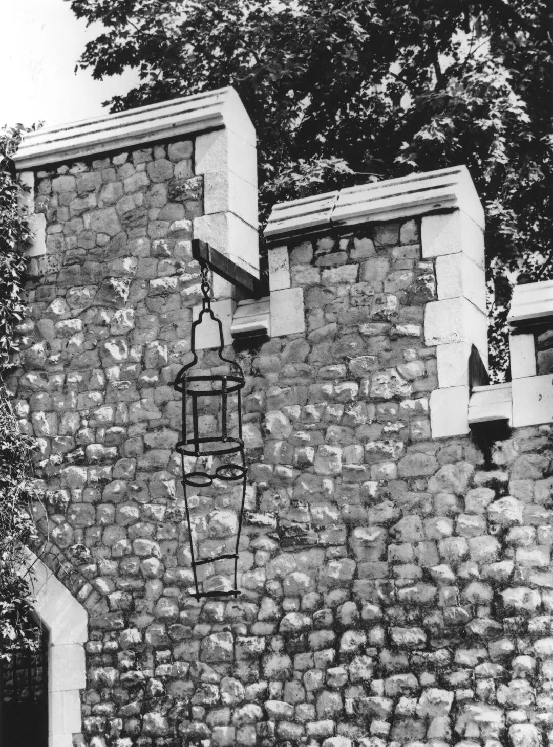 Gibbet photographed hanging off a stone wall
