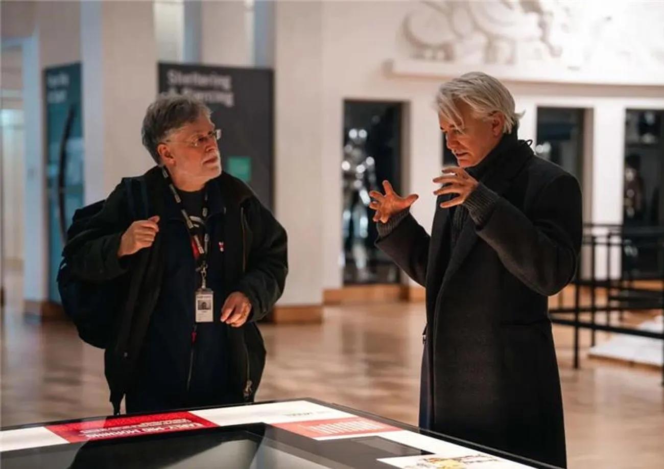 Baz Luhrmann and Robert Woosnam-Savage discussing a display in the royal armouries gallery