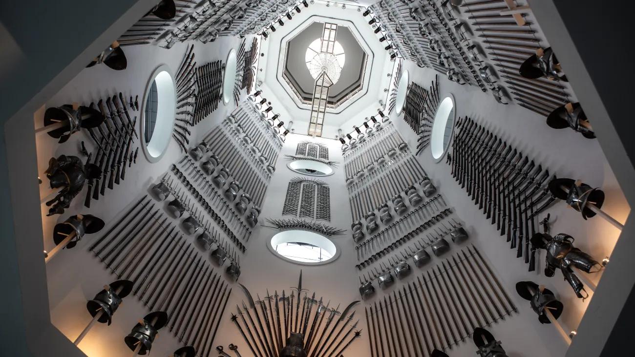 A photo of the Hall of Steel with thousands of weapons and pieces of armour lining the wall