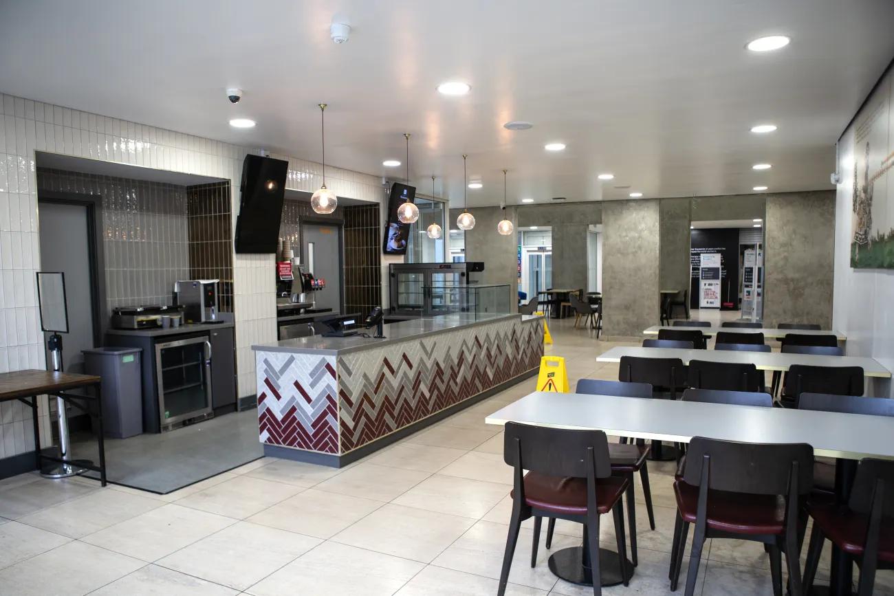 A small cafe with a few tables and chairs arrayed outside the main countertop