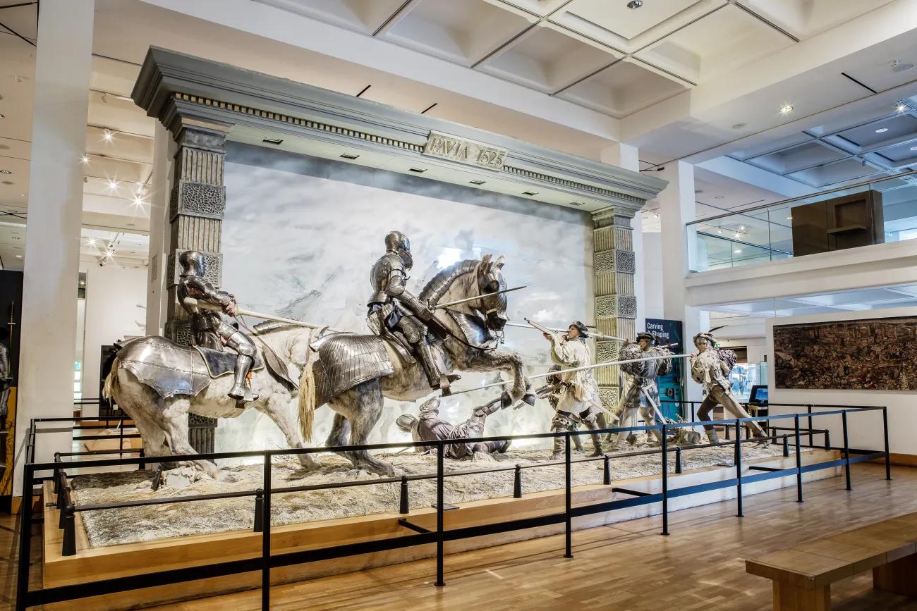 A battle scene of Pavia where mannequins on horseback in full plate armour are held back by mannequins with pikes in Renaissance dress.