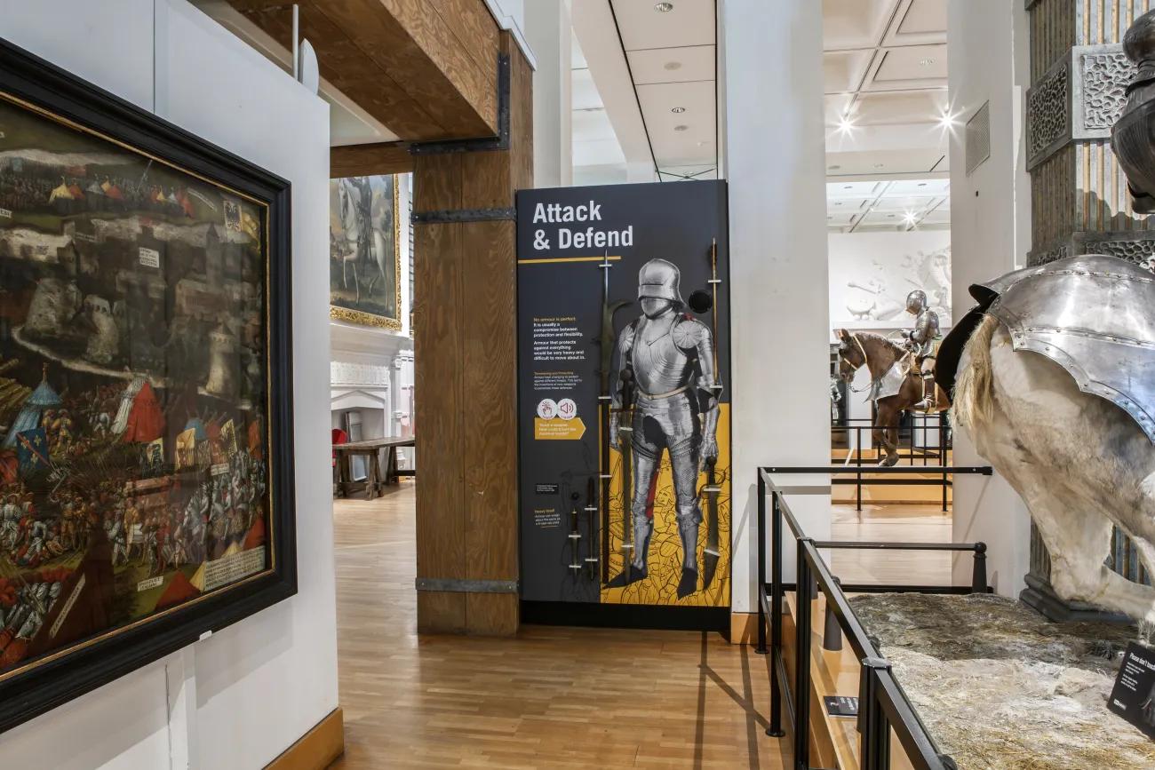 An interactive display allowing children to feel weapons such as polearms and swords used during the late Medieval era.