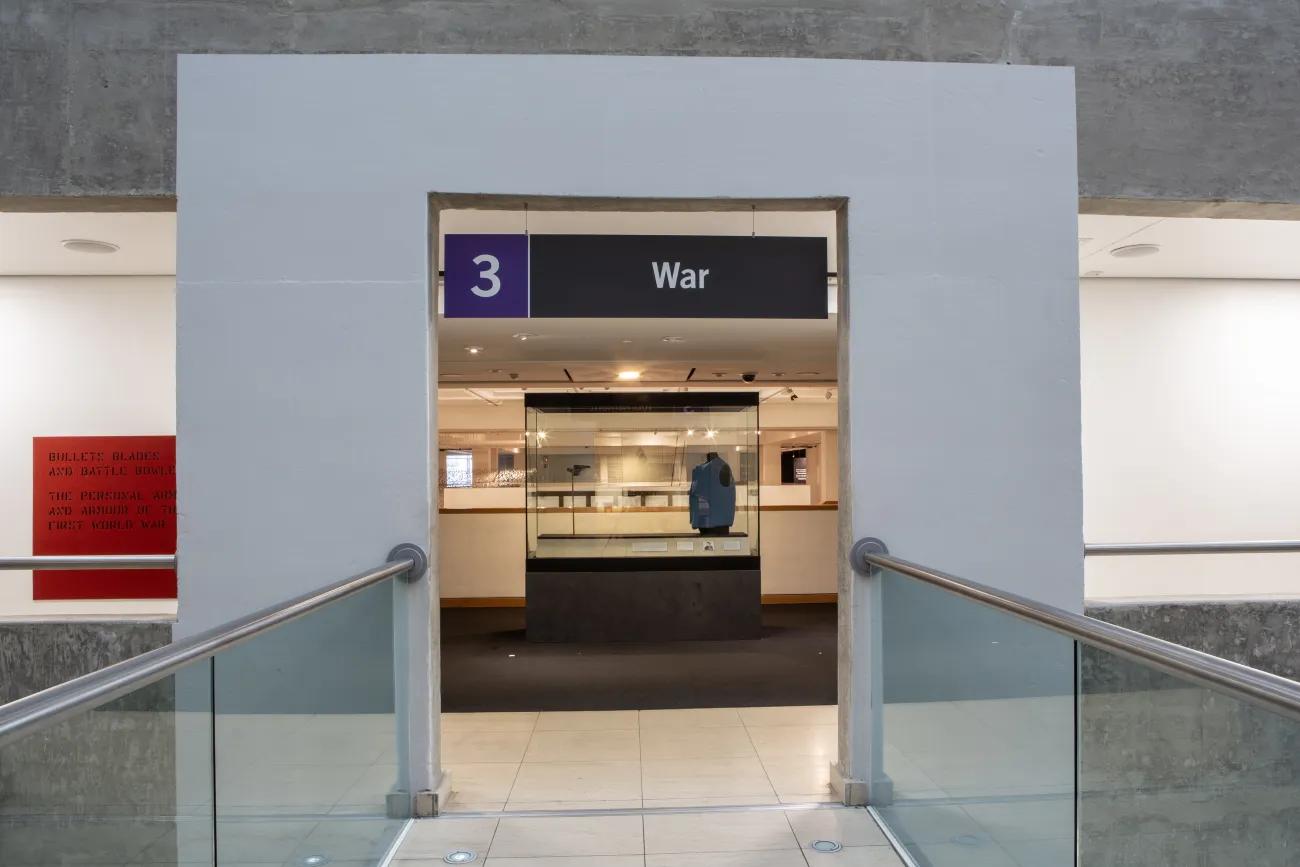 A concrete archway entrance to a third floor gallery on war.