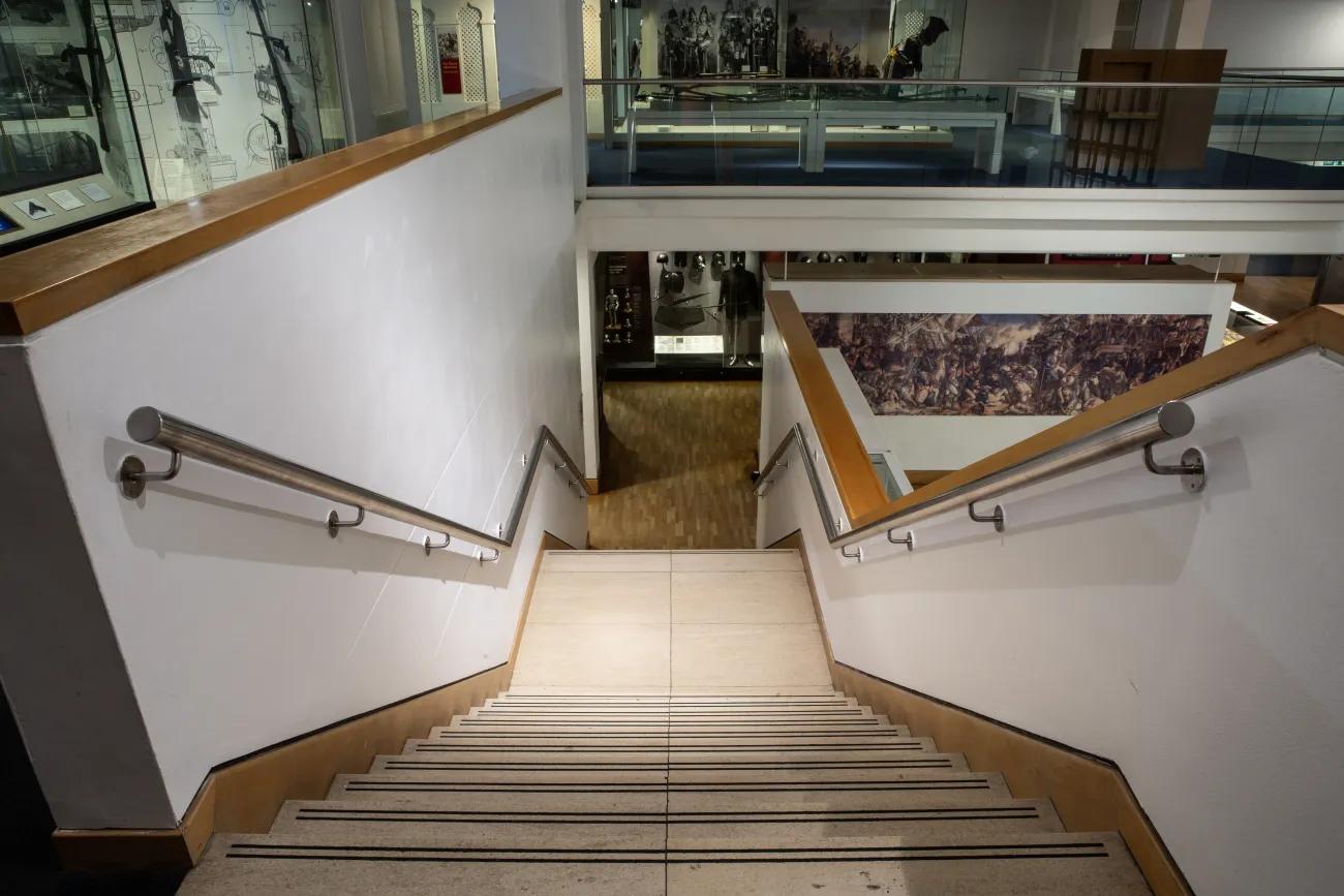 A flight of stairs running down from the third floor of the war gallery to the second floor.