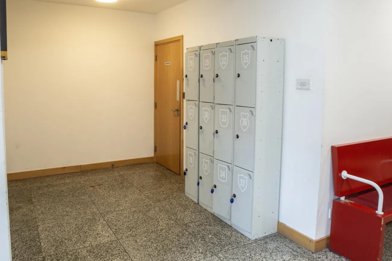 A grey bank of lockers sits alone in a side alcove just off the wide hall with retail cages.