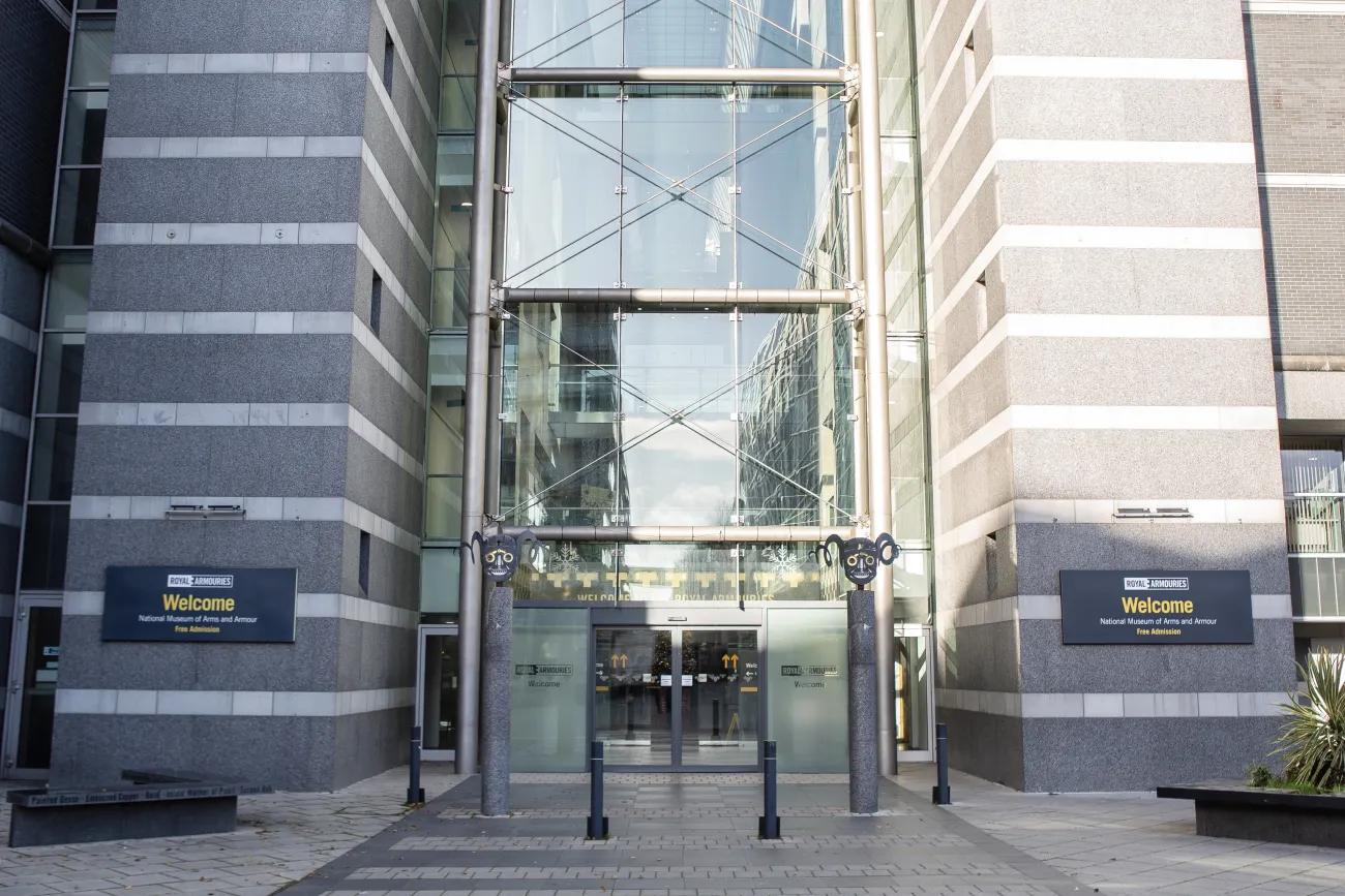 Two grey banded columns flank an entrance way fronted with glass
