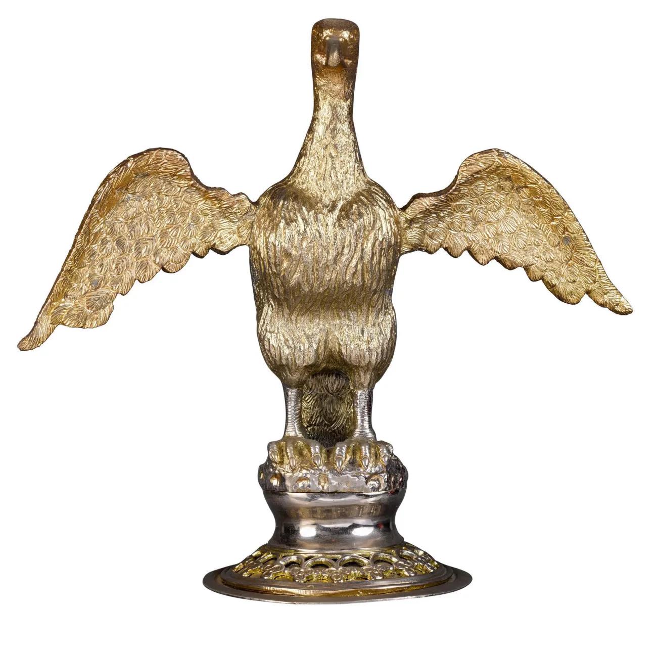 Gold coloured metal vessel in form of an eagle