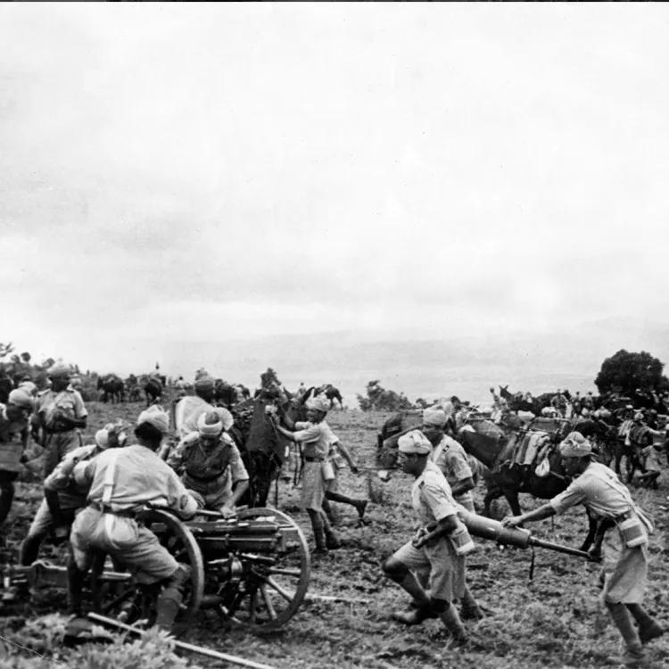 Soldiers preparing for war by transporting ammunition and firearms by mule, cart and hand