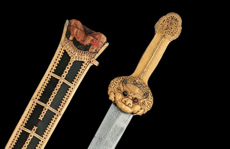 A sword hilt decorated with a dragon in gold
