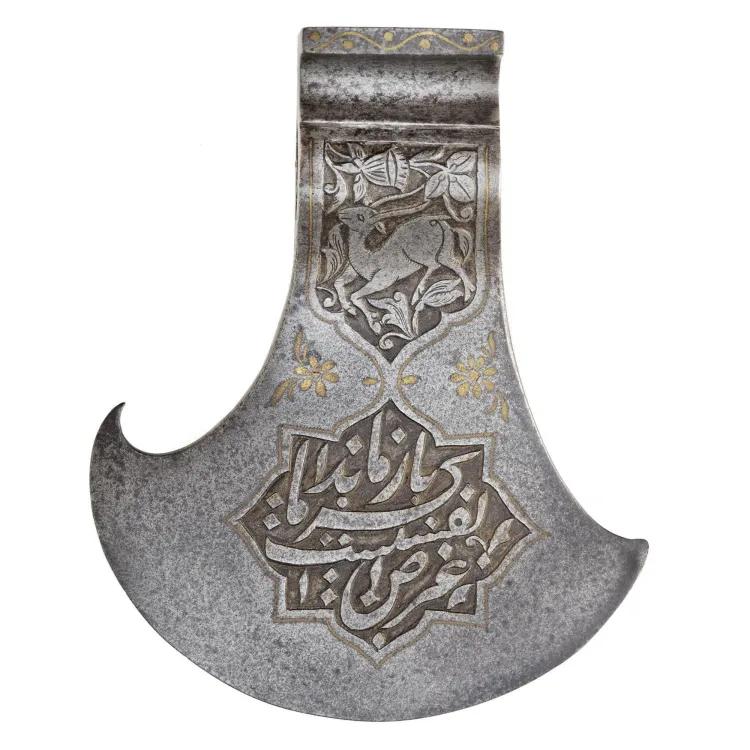 an axe head decorated with a deer below is a cartouche containing Arabic writing