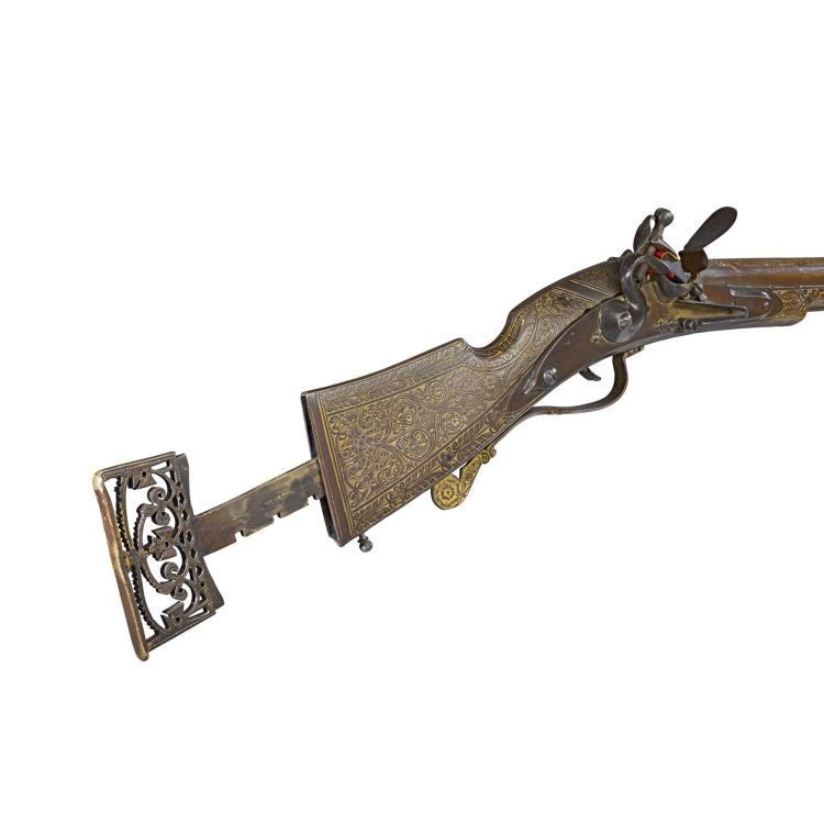 highly decorated gun with flintlock and extending stock