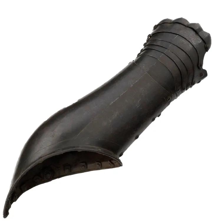 Black colour metal gauntlet covering left hand and arm up to the elbow