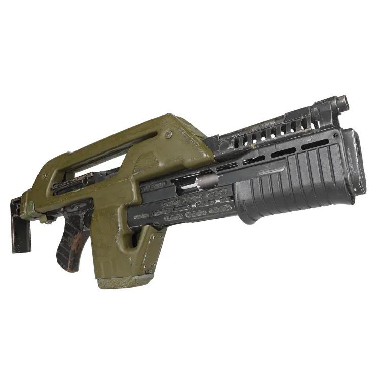 a shotgun shrouded in a green plastic casing to be used as a movie prop