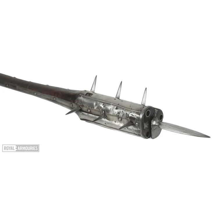 Staff with mace on top that has a three barrelled gun incorporated