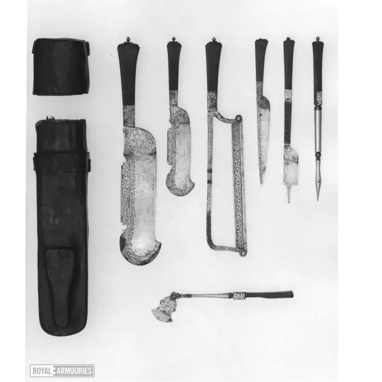Various tools for hunting including multiple knives and a saw