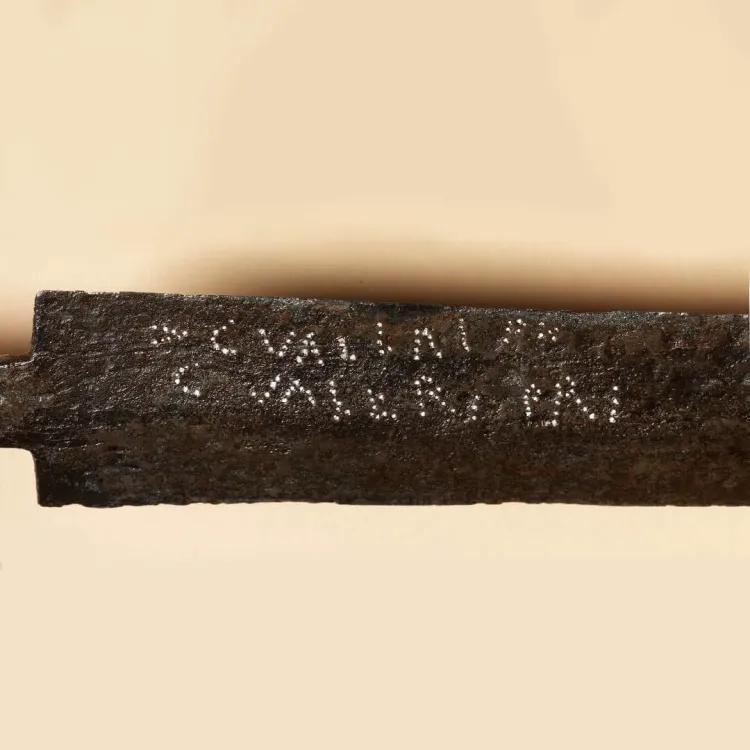 Writing of > C.VALERI[I] C.RANIU[S] and C.VALE[RI] PRIMI on a Roman gladius blade