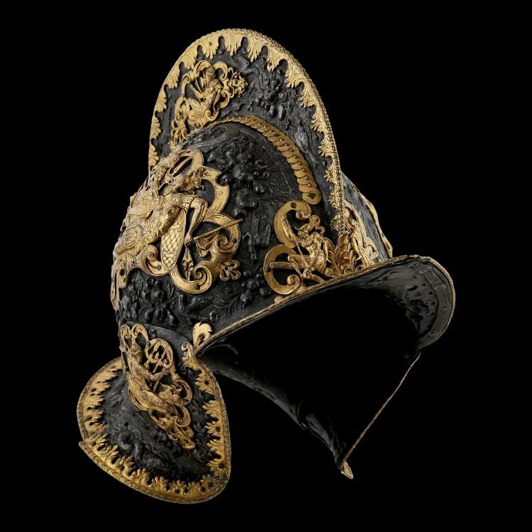 highly embossed helmet with gold decoration. Helmet has a comb high peak and collar
