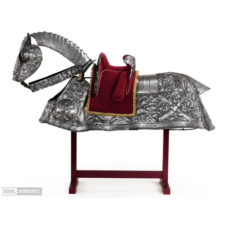 Horse armour on a stand with a red velvet saddle