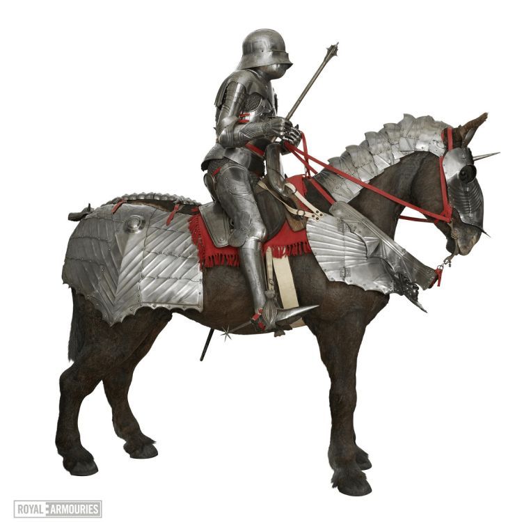 Horse with armour being ridden by a knight in full armour