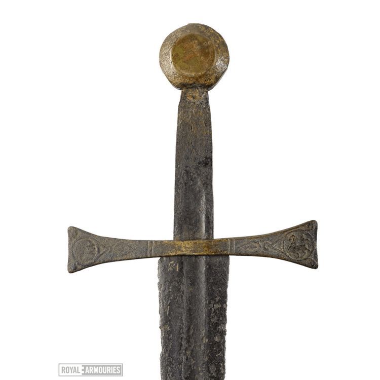 Hilt of arming sword with round pommel and flared cross guard