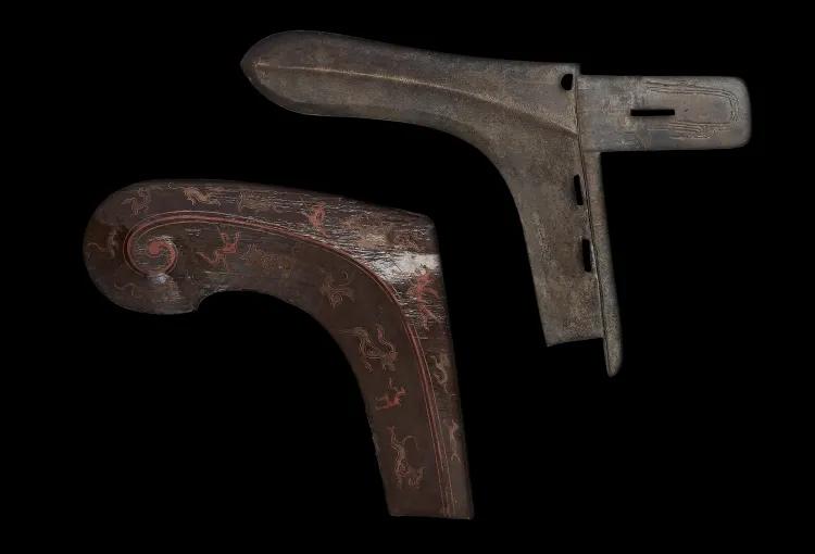 a beak-shaped bronze axe head with brown lacquered scabbard