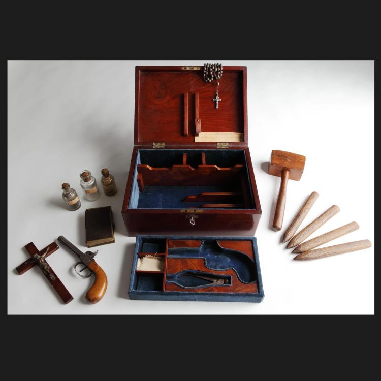 Wooden box with various wooden stakes, mallets, and potions