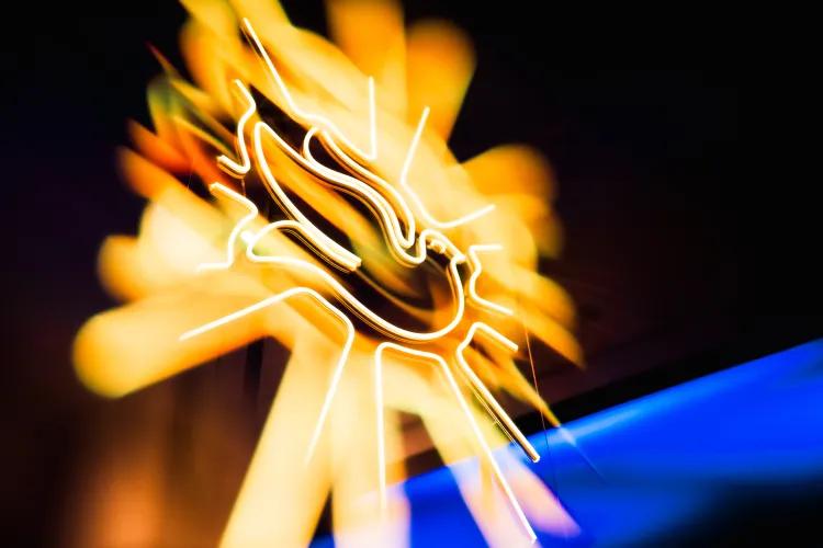 Neon sign glowing yellow around the outline of a dove