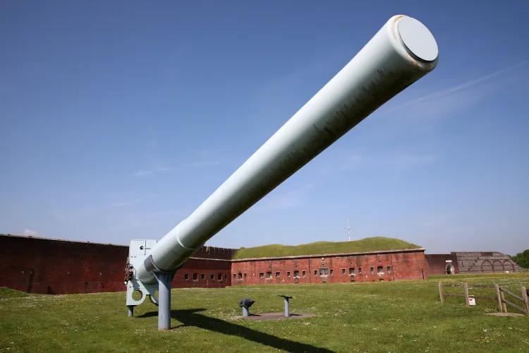 large grey coloured long gun barrel mounted outside of Fort Nelson