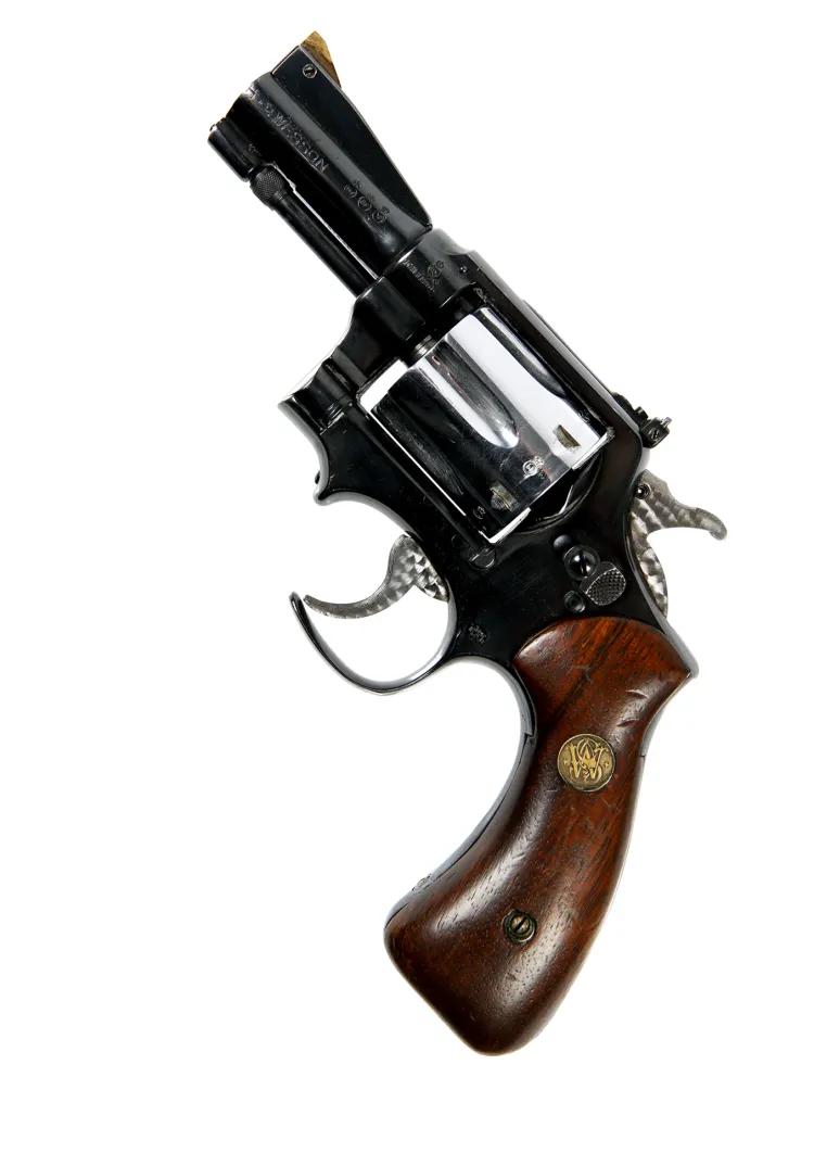 Revolver with cut away trigger guard, shortened barrel and rosewood grips