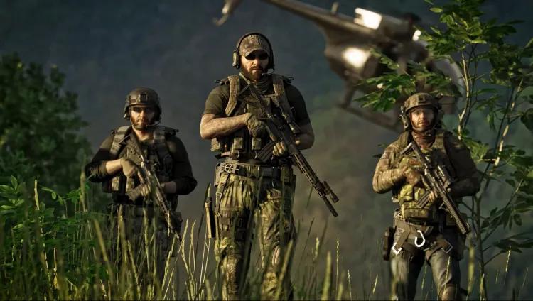 Three soldiers holding firearms with helicopter in the background.
